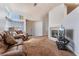 Bright living room featuring a cozy fireplace, carpet floors, and a comfortable seating area at 2086 Angel Falls Dr, Henderson, NV 89074