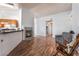 Open living room featuring a cozy fireplace, wood flooring, and neutral paint at 2086 Angel Falls Dr, Henderson, NV 89074