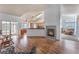 Cozy living room with fireplace and views into the kitchen and sunroom at 2086 Angel Falls Dr, Henderson, NV 89074