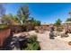 Landscaped backyard with gravel, desert plants, and patio seating, creating a tranquil outdoor living space at 2114 High Mesa Dr, Henderson, NV 89012