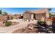 Expansive backyard with desert landscaping, a covered patio, and stylish outdoor decor, perfect for relaxing at 2114 High Mesa Dr, Henderson, NV 89012