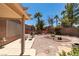 A serene backyard featuring desert landscaping, a covered patio, and ample space for relaxation and enjoyment at 2114 High Mesa Dr, Henderson, NV 89012