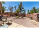 A serene backyard featuring desert landscaping, patio furniture, and ample space for relaxation and enjoyment at 2114 High Mesa Dr, Henderson, NV 89012