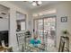 Breakfast nook with glass table, showing view to the covered patio and backyard with fire pit at 2114 High Mesa Dr, Henderson, NV 89012