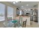Bright breakfast nook with a view into the kitchen and stainless-steel refrigerator at 2114 High Mesa Dr, Henderson, NV 89012