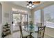 Bright breakfast nook with a glass table, backyard views, and access to the covered patio at 2114 High Mesa Dr, Henderson, NV 89012