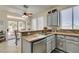 Well-lit kitchen featuring granite countertops, stainless steel appliances, and a view of the backyard at 2114 High Mesa Dr, Henderson, NV 89012
