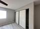Bright bedroom featuring sleek floors, a window, and closet with sliding doors at 2123 Sleepy Ct, Las Vegas, NV 89106