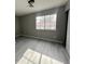 The bedroom includes neutral walls, ceiling fan, large window, and new vinyl plank flooring at 2123 Sleepy Ct, Las Vegas, NV 89106