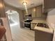 The kitchen includes stainless steel appliances, stylish cabinets, and new countertops and flooring at 2123 Sleepy Ct, Las Vegas, NV 89106
