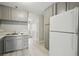This kitchen features ample storage with a refrigerator and lots of upper and lower cabinets at 2123 Sleepy Ct, Las Vegas, NV 89106