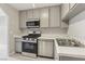 Well-lit kitchen features stainless steel appliances, updated cabinets, and a white countertop at 2123 Sleepy Ct, Las Vegas, NV 89106
