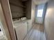 The laundry room includes a washer, dryer, shelving and access to outside at 2123 Sleepy Ct, Las Vegas, NV 89106