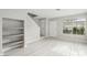 Bright living room with light wood floors, open shelving, and a view to the front yard at 2123 Sleepy Ct, Las Vegas, NV 89106