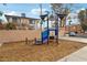 Community playground with modern play structure and wood chip ground cover near residential buildings at 2123 Sleepy Ct, Las Vegas, NV 89106