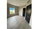 Bedroom showcasing ample natural light and modern fixtures, plus wood-look flooring at 2151 Hussium Hills St # 207, Las Vegas, NV 89108