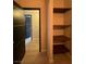Hallway featuring access to other rooms and a shelving unit at 2151 Hussium Hills St # 207, Las Vegas, NV 89108