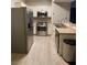 A kitchen featuring stainless steel appliances and bright white cabinetry and wood floors at 2151 Hussium Hills St # 207, Las Vegas, NV 89108