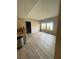 A bright living room with light-colored wood floors and large windows at 2151 Hussium Hills St # 207, Las Vegas, NV 89108