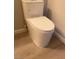 Close-up of a modern, white toilet with a sleek design on wood-look flooring at 2151 Hussium Hills St # 207, Las Vegas, NV 89108
