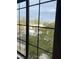 A view from a window overlooking a community street and mature trees at 2151 Hussium Hills St # 207, Las Vegas, NV 89108