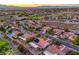 Stunning aerial view capturing the community homes, adjacent golf course, and the vibrant cityscape beyond at 2319 Hardin Ridge Dr, Henderson, NV 89052