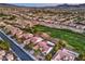 Beautiful aerial view of community homes and the verdant golf course, set against a desert landscape at 2319 Hardin Ridge Dr, Henderson, NV 89052