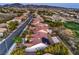 Aerial view shows homes with solar panels in a golf course community and desert landscape at 2319 Hardin Ridge Dr, Henderson, NV 89052
