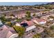 Aerial view displays homes with solar panels in a golf course community amidst a desert landscape at 2319 Hardin Ridge Dr, Henderson, NV 89052