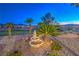 Private backyard featuring desert landscaping, putting green views and a tranquil fountain at 2319 Hardin Ridge Dr, Henderson, NV 89052