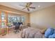 Bright bedroom with a ceiling fan, large window, and views of mountains at 2319 Hardin Ridge Dr, Henderson, NV 89052