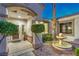Inviting front entrance showcasing lush landscaping, a charming fountain, and a cozy, welcoming atmosphere at 2319 Hardin Ridge Dr, Henderson, NV 89052