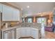 Kitchen featuring stainless dishwasher, stone countertops and view to the living room at 2319 Hardin Ridge Dr, Henderson, NV 89052