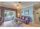 Inviting living room with a comfortable couch and sliding glass doors to the outdoor patio at 2319 Hardin Ridge Dr, Henderson, NV 89052
