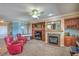 Cozy living room with a fireplace, built-in shelving, comfortable seating, and neutral carpet at 2319 Hardin Ridge Dr, Henderson, NV 89052