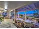 Relaxing outdoor patio with comfortable seating, covered pergola, and serene views of the manicured backyard at 2319 Hardin Ridge Dr, Henderson, NV 89052