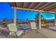 Inviting outdoor seating area with a table and chairs, under a covered patio with mountain views at 2319 Hardin Ridge Dr, Henderson, NV 89052