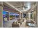 Inviting covered patio featuring wicker seating, a ceiling fan, and a view of the garden at 2319 Hardin Ridge Dr, Henderson, NV 89052