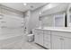 A clean and bright bathroom featuring tile floors, double vanity, and shower and bath at 2456 Bagnara Pl, Henderson, NV 89044