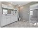 Bright bathroom with double vanity sinks, tile floors, and large mirror at 2456 Bagnara Pl, Henderson, NV 89044