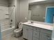 Bathroom with shower-tub combo, single sink vanity with white cabinets, and neutral finishes at 2456 Bagnara Pl, Henderson, NV 89044