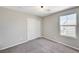 A bright bedroom featuring plush gray carpeting, neutral walls, a window, and a closet at 2456 Bagnara Pl, Henderson, NV 89044