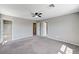 Bright bedroom with carpet, ceiling fan, and access to an ensuite bathroom at 2456 Bagnara Pl, Henderson, NV 89044