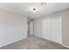 A spacious bedroom featuring plush gray carpeting, neutral walls, a window, and a closet at 2456 Bagnara Pl, Henderson, NV 89044