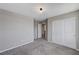 A spacious bedroom featuring plush gray carpeting, neutral walls, and a double door closet at 2456 Bagnara Pl, Henderson, NV 89044