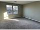 Bright, carpeted bedroom featuring large windows overlooking the neighborhood at 2456 Bagnara Pl, Henderson, NV 89044