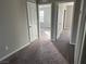 Neutral bedroom with two doorways, carpet and ample sunlight at 2456 Bagnara Pl, Henderson, NV 89044