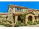 Charming two-story townhome with desert landscaping, tile roof, and neutral-colored exterior paint at 2456 Bagnara Pl, Henderson, NV 89044