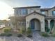 Two story home featuring a brick pathway, arched entryway and covered porch at 2456 Bagnara Pl, Henderson, NV 89044