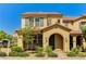 Inviting two-story townhome with a tile roof, archway entry and desert landscaping at 2456 Bagnara Pl, Henderson, NV 89044